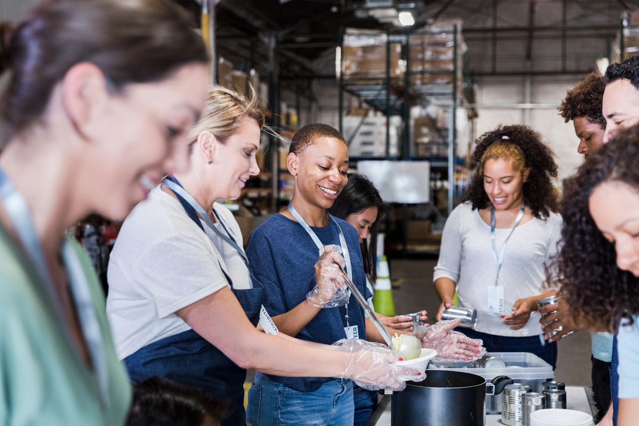Volunteers working together in a warehouse to serve food