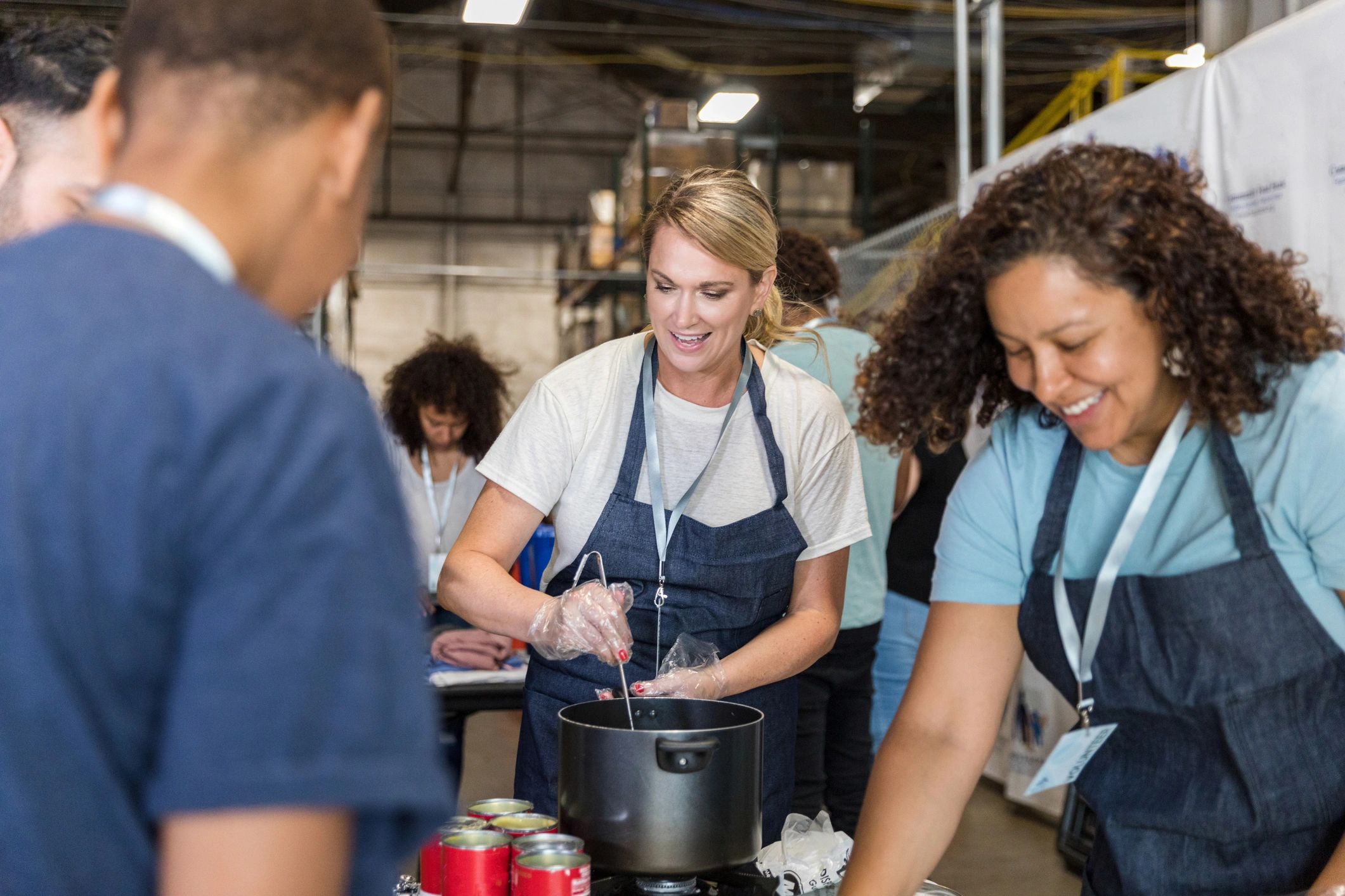 Multiracial volunteer group prepares meals for soup kitchen